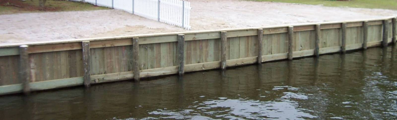 Wooden bulkhead along the water